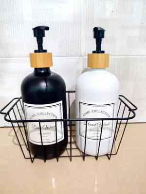 two bottles of soap in a black holder at Rara Homestay Kuala Kangsar in Kuala Kangsar