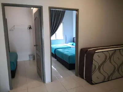 a bedroom with a bed and a mirror in a room at My Homestay N18 (14 pax) @ Golden Hills Night Market in Brinchang