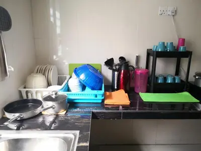 a kitchen counter top with a sink and some dishes at My Homestay N18 (14 pax) @ Golden Hills Night Market in Brinchang
