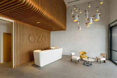 a lobby with a table and chairs and a chandelier at OZO George Town Penang in George Town