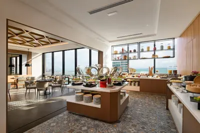 a restaurant with a view of the ocean at OZO George Town Penang in George Town