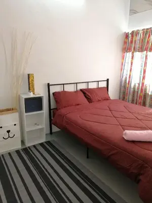 a bedroom with a red bed and a tv at little heritage home in George Town
