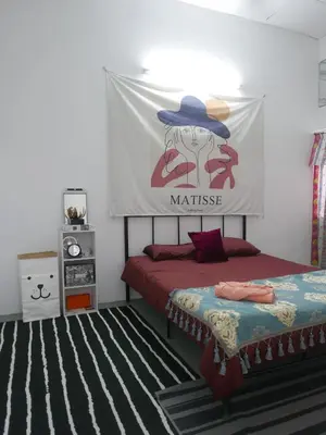 a bedroom with a bed with a sign on the wall at little heritage home in George Town