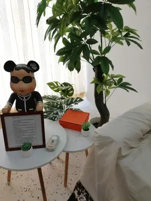 a teddy bear sitting on a table in a bedroom at little heritage home in George Town