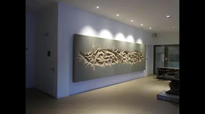 a room with a large painting on the wall at By the sea Duplex penthouse baby in Batu Ferringhi