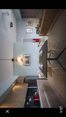 a kitchen with a stove and a refrigerator at By the sea Duplex penthouse baby in Batu Ferringhi