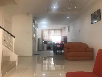 a living room with a couch and a table at Island Hostel Bayan Lepas Airport in Bayan Lepas