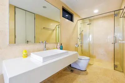 a bathroom with a white sink and a shower at Jazz Service Suites Penang in George Town