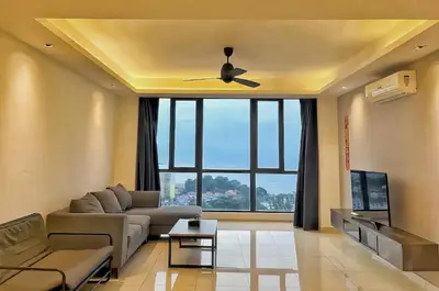 a living room with a couch and a ceiling fan at Jazz Service Suites Penang in George Town