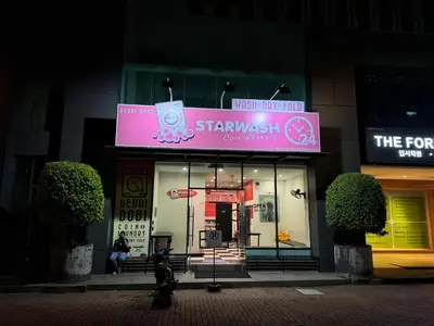 a pink sign on the front of a store at Jazz Service Suites Penang in George Town
