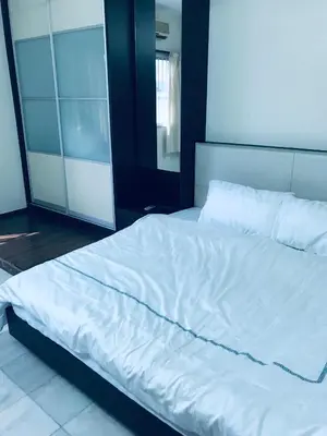 a large bed with white sheets and pillows at CoZy and comfortable Homestay in sungai siput in Sungai Siput