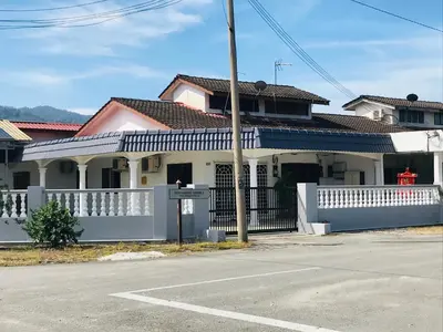 a white house with a white fence and a street at CoZy and comfortable Homestay in sungai siput in Sungai Siput