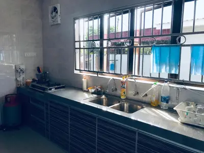 a kitchen with a sink and two windows at CoZy and comfortable Homestay in sungai siput in Sungai Siput