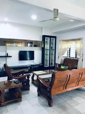 a living room with wooden furniture and a flat screen tv at CoZy and comfortable Homestay in sungai siput in Sungai Siput