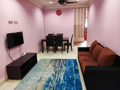 a living room with a couch and a dining room at Homestay D'Lily in Ipoh