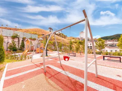 a playground with a swing set in a park at Golden Sweet Home @ CH Golden Hills (Night Market) in Cameron Highlands