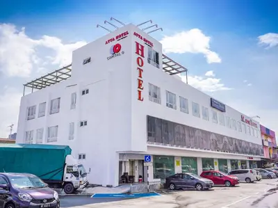 a large white building with cars parked in a parking lot at Avatel Bukit Mertajam in Bukit Mertajam