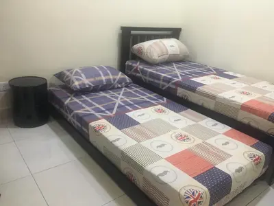 two beds sitting next to each other in a room at Cozy Corner Homestay in Kepala Batas