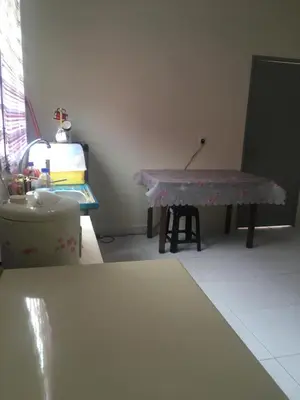 a living room with a table and a sink at Cozy Corner Homestay in Kepala Batas