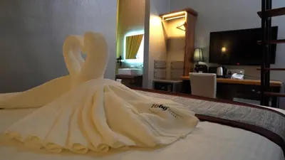 a wedding dress is sitting on a bed at 1969 Business Suites @ Ipoh Garden in Ipoh
