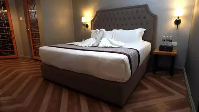 a hotel room with a large bed with white pillows at 1969 Business Suites @ Ipoh Garden in Ipoh
