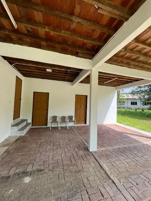 a patio with two chairs and a wooden ceiling at Suri Homestay, Taiping in Taiping