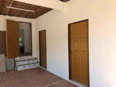 an empty room with two doors and a mirror at Suri Homestay, Taiping in Taiping