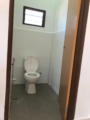 a small bathroom with a toilet with a window at Suri Homestay, Taiping in Taiping