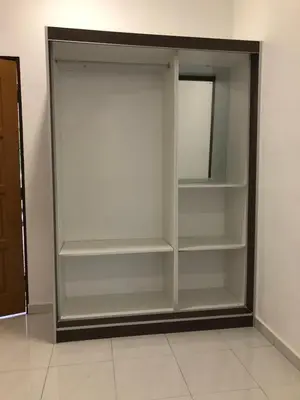a closet with white shelves in a room at Suri Homestay, Taiping in Taiping