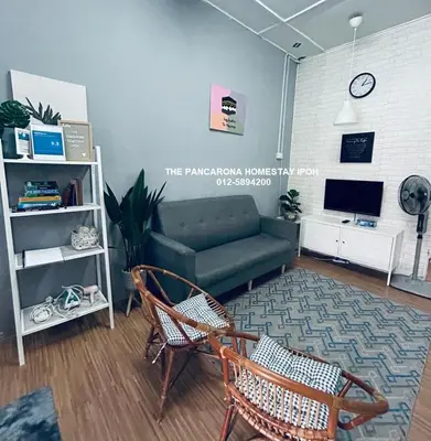 a living room with a couch and a chair at The Pancarona Homestay forMuslims, Ipoh, Perak in Ipoh