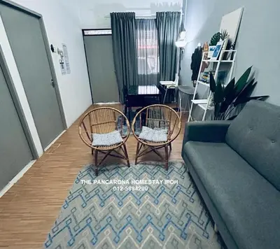 a living room with two chairs and a couch at The Pancarona Homestay forMuslims, Ipoh, Perak in Ipoh