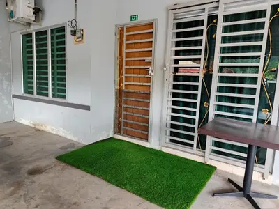 a room with a table and a window with green grass at RIZQI HOMESTAY Sungai Siput with Wifi! Islamic Guest Only! in Kampong Rimba Panjang