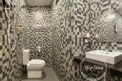 a bathroom with a white toilet and a sink at YipStay in Gopeng