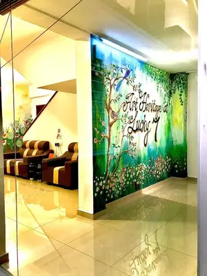 a room with a wall with a mural of a tree at Art Heritage at Lucky 7 in Ipoh