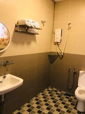 a bathroom with a toilet and a sink at Art Heritage at Lucky 7 in Ipoh