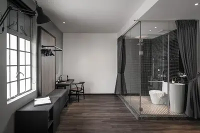 a bathroom with a glass shower and a table at Modern Hotel Georgetown in George Town