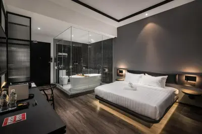 a bedroom with a large bed and a bath tub at Modern Hotel Georgetown in George Town