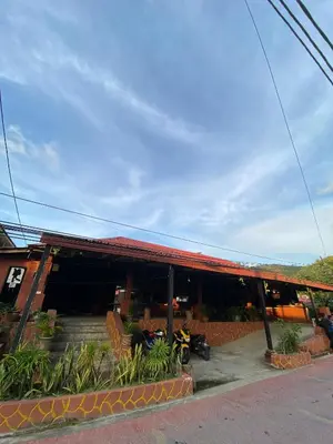 a building with a motorcycle parked in front of it at INTAN CHALEt in Pangkor