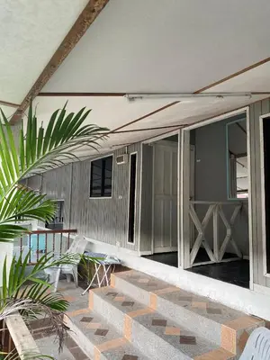 a patio of a house with a table and chairs at INTAN CHALEt in Pangkor