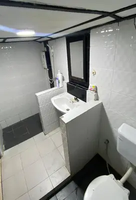 a bathroom with a sink and a toilet and a mirror at INTAN CHALEt in Pangkor