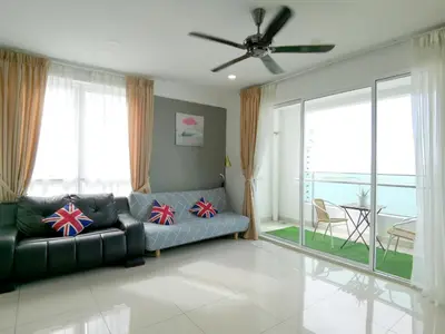a living room with a couch and a ceiling fan at Seaview Mansion One Georgetown in George Town