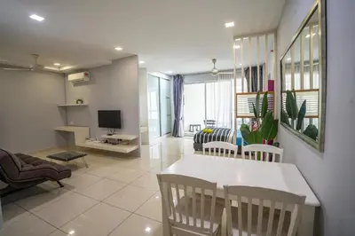 a living room with a white table and chairs at Seaview Mansion One Georgetown in George Town