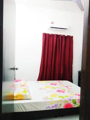 a bedroom with a bed with a red curtain at Homestay Musafir Apartment Seri Iskandar 2.0 in Seri Iskandar