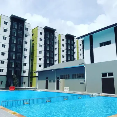 an empty swimming pool in front of some buildings at Homestay Musafir Apartment Seri Iskandar 2.0 in Seri Iskandar