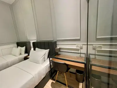 a small room with a bed and a desk at Wesley Hotel in Bukit Mertajam