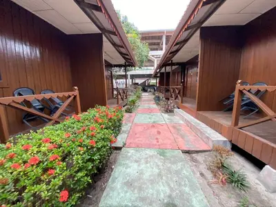 a walkway with flowers on the side of a building at PANGKOR PURNAMA CHALET in Pangkor