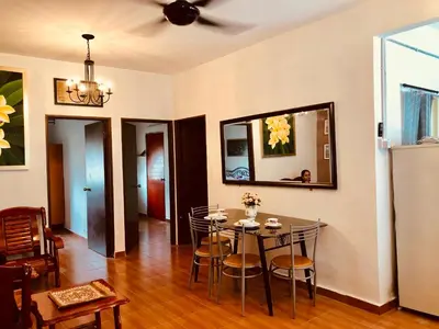 a dining room with a table and chairs at Sinar Ara homestay in Lunas