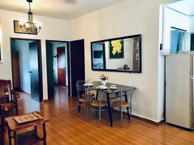 a dining room with a table and chairs at Sinar Ara homestay in Lunas