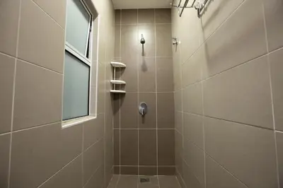 a bathroom with a shower with a window at Barrington Villa @ Golden Hill in Cameron Highlands