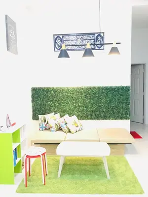 a living room with a white couch and a green wall at Bismillah Homestay Muslem NETFLIX UNIFI HIGH SPEED in Kamunting